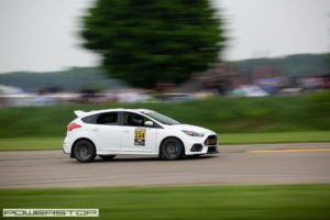 White Ford Focus RS race car driving on a track.